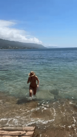 Beach day captured at Bulli with surfboard and swimmers