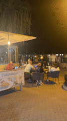 Late-night cafe gathering with live music in Cala Rajada