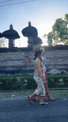 Traditional Balinese women carry baskets along Tegallalang road