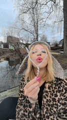 Woman with bubble wand enjoys outdoor moment in Noviy