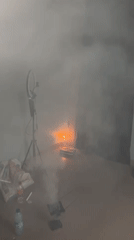 Smoke-filled ceremony with candles and white robes in Badagry