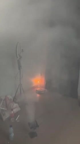 Smoke-filled ceremony with candles and white robes in Badagry