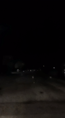 Purple light flash captured on dark road in Bulgaria