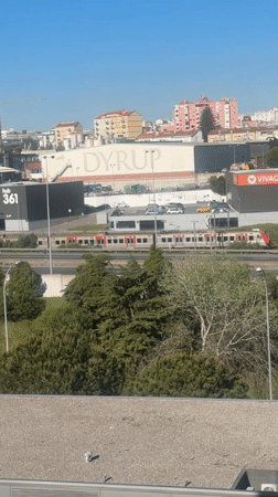 Train travels through Unhos highway amid clear skies