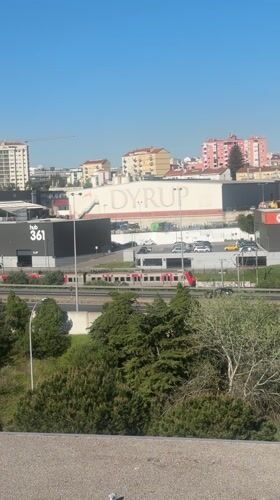 Train travels through Unhos highway amid clear skies