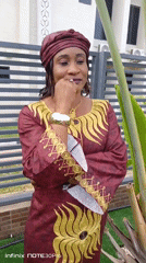 Woman poses for traditional portrait session in Akwanga garden