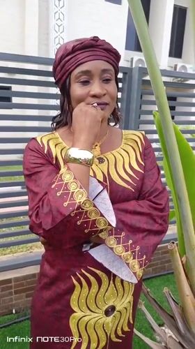Woman poses for traditional portrait session in Akwanga garden