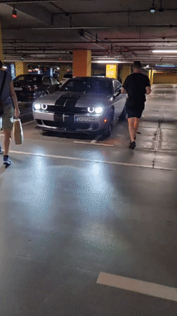 Silver Dodge Challenger with racing stripes spotted in garage