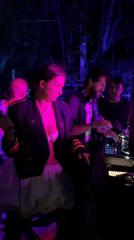 Woman with microphone performs alongside smoking DJ in Ko Samui