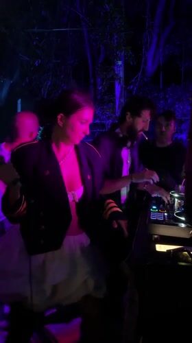 Woman with microphone performs alongside smoking DJ in Ko Samui