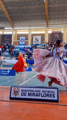 Girls perform traditional Marinera dance at Miraflores gymnasium