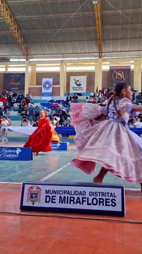 Girls perform traditional Marinera dance at Miraflores gymnasium