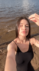 Woman films selfie content on Chaikovsky beach