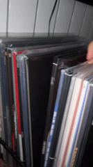 Music enthusiast browses vinyl collection in Yerevan apartment