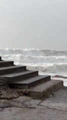 Evening beach activities captured along Portuguese coast during stormy weather