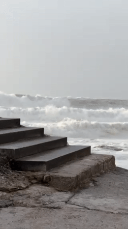 Evening beach activities captured along Portuguese coast during stormy weather
