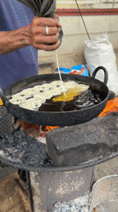 Street food vendors cook breakfast dishes in Bengaluru