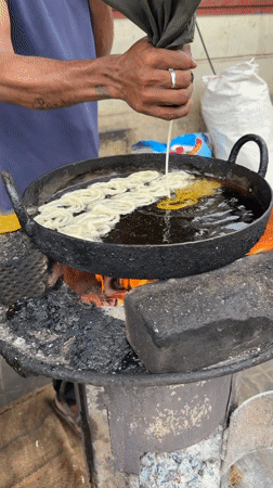 Street food vendors cook breakfast dishes in Bengaluru