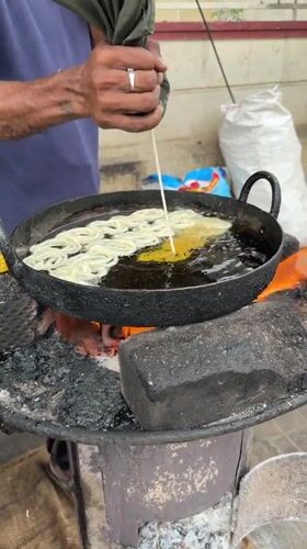 Street food vendors cook breakfast dishes in Bengaluru