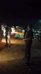 Nighttime street gathering with auto-rickshaws documented in Bukuru