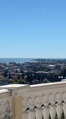 Woman documents coastal city tour with protein bars, panoramic views