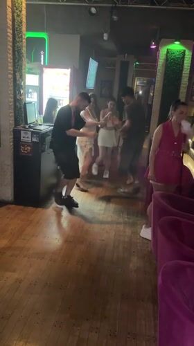 Dancing and gathering at a dim indoor venue in Varna