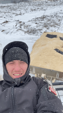 Person rides vehicle roof rack through snowy Sarapul streets