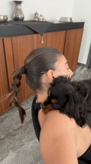 Woman bonds with Cavalier King Charles puppies in Puebla