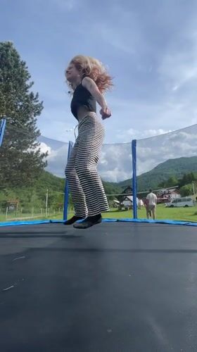 Woman trampolines in rural Montenegro, local flora documented