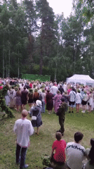 Midsummer festival at a lakeside clearing: dancing, flower crowns, pole