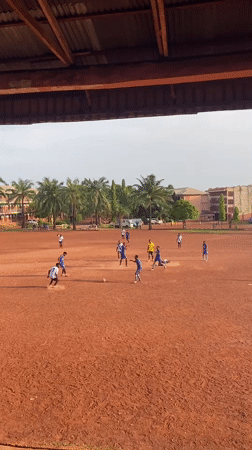 Soccer match played on red dirt field in Abakaliki