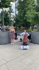 Street musicians perform near Moscow fountain as pedestrians pass