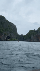 Choppy waters and limestone cliffs captured in Ao Nang