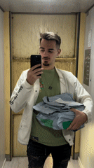 Man with packages mentions buying present in Sofia elevator