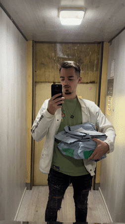 Man with packages mentions buying present in Sofia elevator
