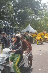 Festive street parade rolls through Sungailiat, Indonesia