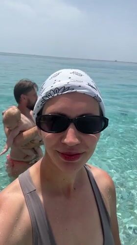 Woman takes selfie in turquoise waters off Fethiye beach