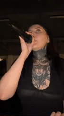 Evening at home: singing woman and sleeping cat in Russia