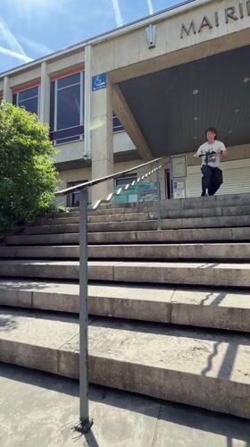 Scooter tricks performed on Lyon sidewalk and stairwell