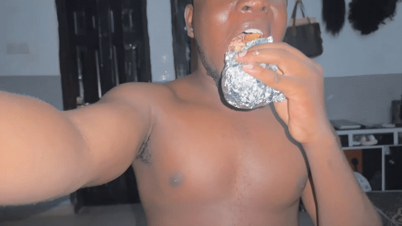 Man eats foil-wrapped meal in Gbongan room