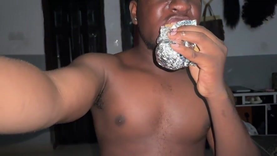 Man eats foil-wrapped meal in Gbongan room