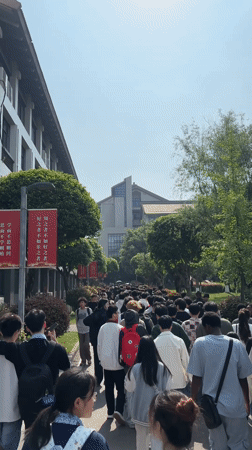Large crowd walks university campus in Jiangjin at night