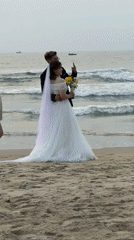 Wedding couple poses for beach photos in Đà Nẵng