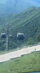Tourist enjoys cable car and mountain dining at Roza Khutor
