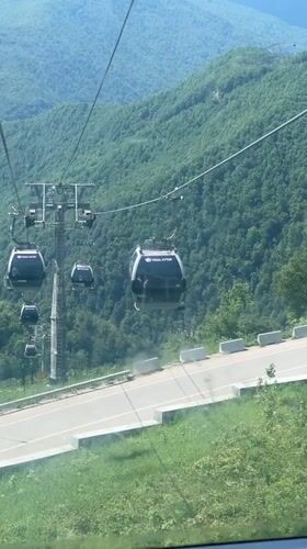 Tourist enjoys cable car and mountain dining at Roza Khutor