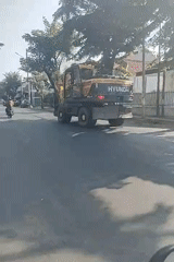 Morning traffic and construction equipment near Gelora 10 November Stadium