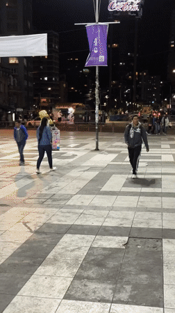 Street musician plays clarinet at night in La Paz