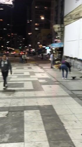 Street musician plays clarinet at night in La Paz