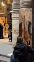 Artist paints inside historical building near Jerusalem's Holy Sepulchre