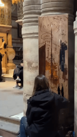 Artist paints inside historical building near Jerusalem's Holy Sepulchre